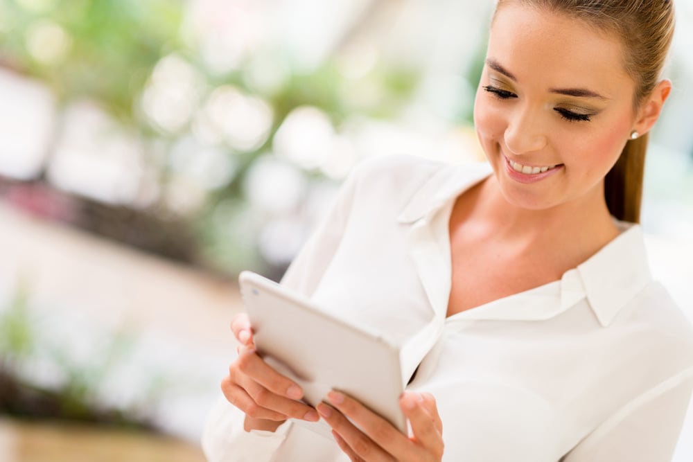 Business woman using app on a tablet computer